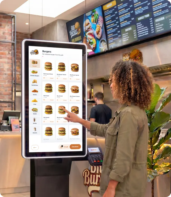 Woman ordering on the Bistroo Kiosk